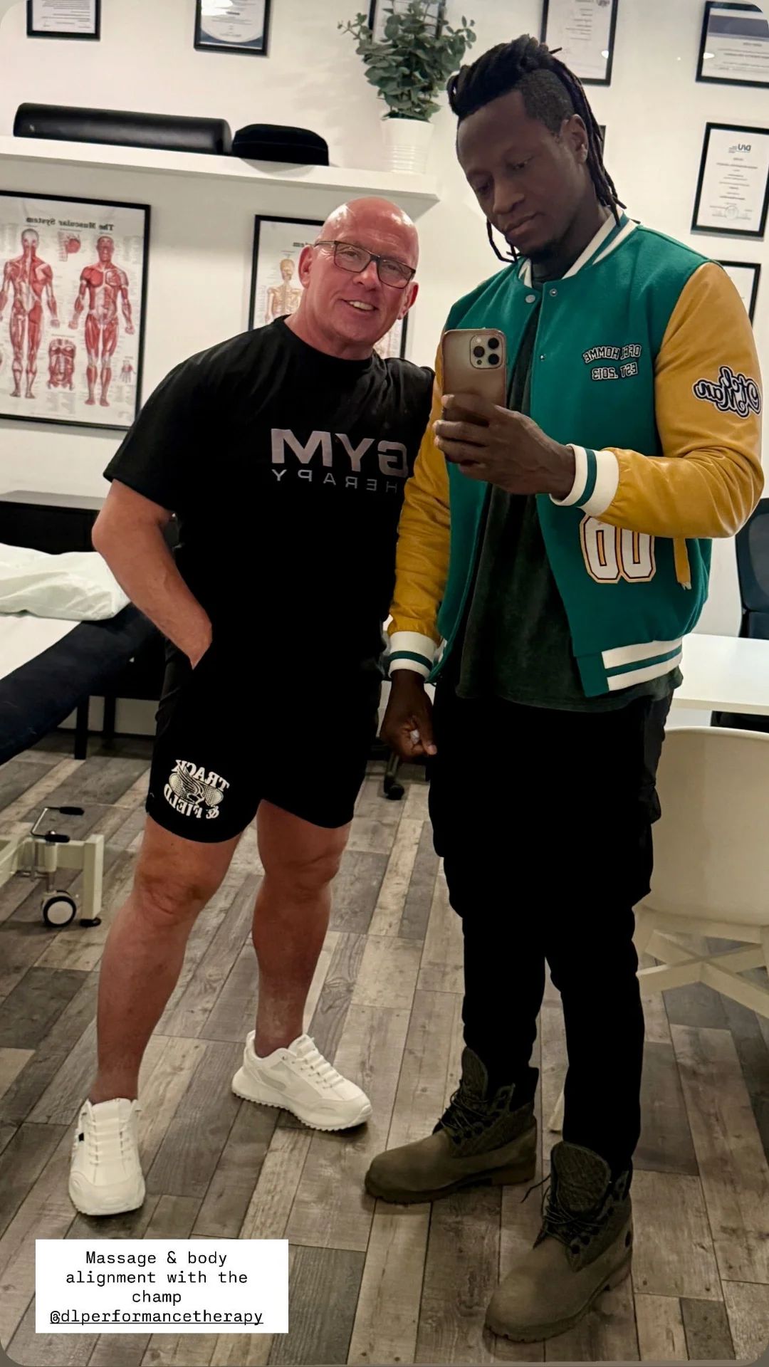 Derek Lyons sports massage therapist with professional athlete in London clinic